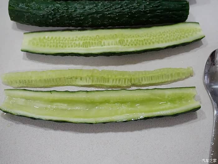 黄瓜切掉两头.对半切开. 用不锈钢勺或小刀把中间的瓤去掉.